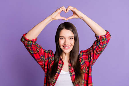 Photo of flirty brunette hairdo millennial lady show heart wear red shirt isolated on purple color backgroundの写真素材