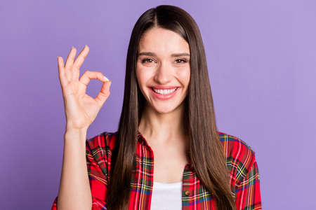 Photo of cool long hairdo young lady show okey sign wear red shirt isolated on violet color backgroundの写真素材