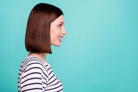Photo of charming cute positive lady look empty space wear striped shirt isolated on turquoise color backgroundの写真素材