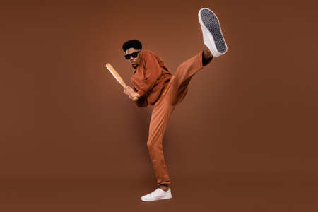 Full body photo of serious short hairdo young guy hit fight dress spectacles sportswear trousers sneakers isolated on brown backgroundの写真素材