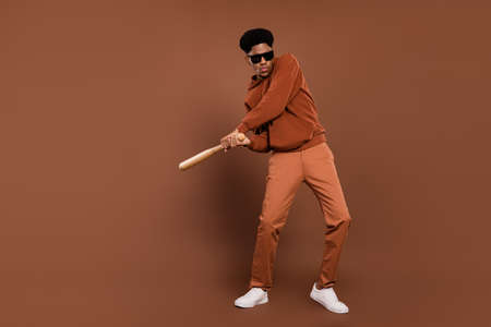 Full size photo of strong short hairdo young guy hit dress spectacles sportswear trousers sneakers isolated on brown backgroundの写真素材