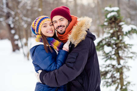 Photo of cheerful young man charming lady hugging toothy smile look camera spend weekend forest outdoorsの写真素材