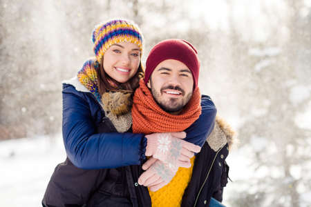 Portrait of handsome cheerful guy hold on back pretty positive lady look camera enjoy walking in woods outdoorsの写真素材