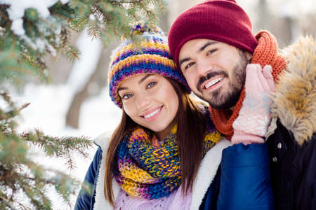Photo of young cheerful attractive couple happy positive smile forest husband wife love romantic winterの写真素材