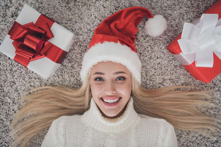 Top above high angle view photo of young cheerful girl happy positive smile lying floor present box holiday indoorsの写真素材