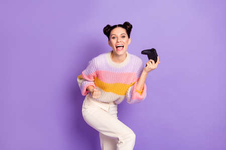 Portrait of lovely cheerful girl playing game celebrating having fun contest isolated on bright...