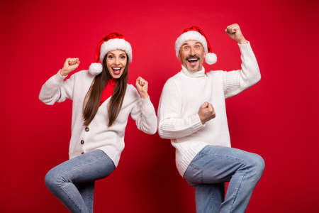 Portrait of attractive lucky cheerful couple rejoicing dancing having fun eve time isolated over bright red color backgroundの写真素材
