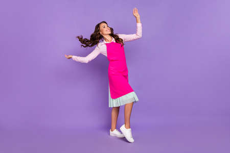Full length photo of satisfied overjoyed girl enjoy dancing inspiration dream isolated on purple color backgroundの写真素材