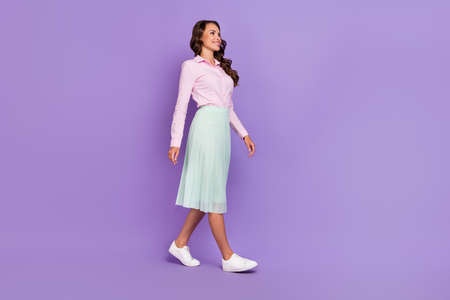 Full length profile photo of nice millennial brunette lady go wear shirt skirt shoes isolated on...