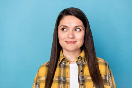 Photo of attractive mature woman happy positive smile wonder interested look empty space isolated over blue color backgroundの写真素材
