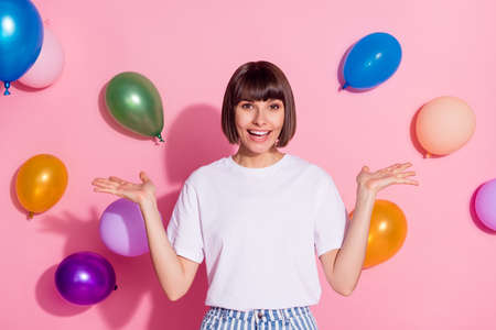 Portrait of attractive cheerful girl having fun celebrating fest good mood air balls flying isolated...