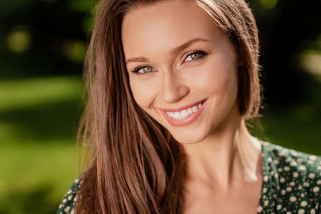 Photo of pretty cute cheerful glad lady beaming shiny smile wear green dress nature park garden outdoorsの写真素材