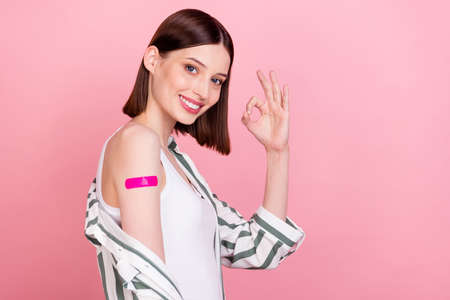 Profile side photo of young girl happy positive smile show alright sign vaccination immunization...