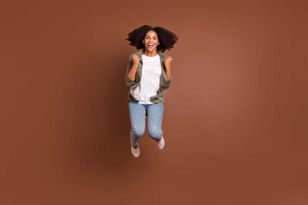 Full size photo of funky millennial brunette lady jump wear shirt jeans shoes isolated on brown...
