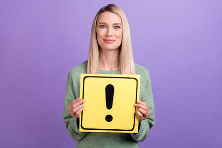Photo of attractive young lady good mood dangerous exclamation mark isolated over purple color backgroundの写真素材