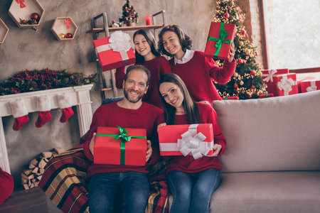 Photo of cute excited brother sister husband wife getting noel presents having rest hugging smiling indoors room home houseの写真素材