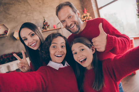 Photo of adorable impressed brother sister husband wife embracing showing v-sign thumb up tacking noel selfie indoors room home houseの写真素材