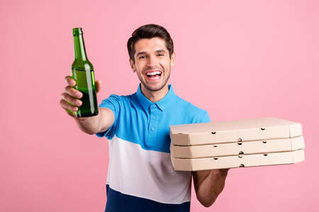 Photo of funky brunet millennial guy hold pizza beer wear striped t-shirt isolated on pink color backgroundの写真素材