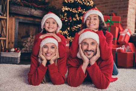 Portrait of beautiful handsome cheerful people family having fun lying on carpet resting at...