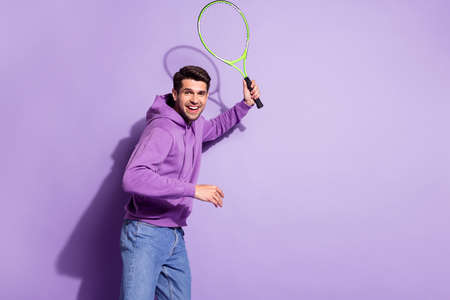Photo portrait man playing tennis in hoody on court isolated pastel violet color backgroundの写真素材