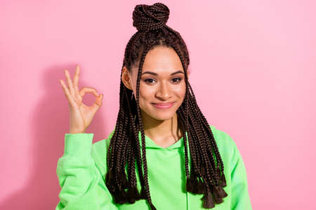 Photo of happy nice young afro american woman make okay sign recommend isolated on pink color...