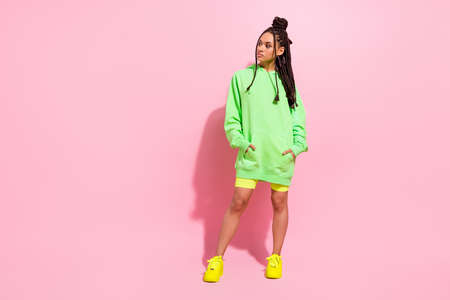 Full size photo of young afro american woman look empty space wear casual outfit isolated on pink...
