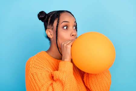 Profile photo of funny young brunette lady blow balloon wear fall orange sweater isolated on blue...