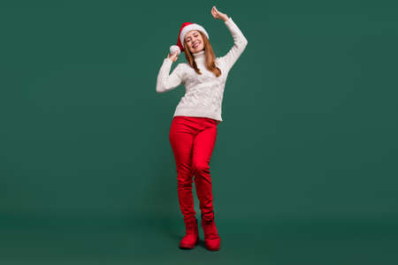 Full length body size view of attractive cheerful dreamy woman dancing festal evening isolated over green color backgroundの写真素材