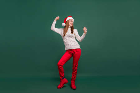 Full length body size view of attractive cheerful dreamy woman having fun resting event isolated over green color backgroundの写真素材