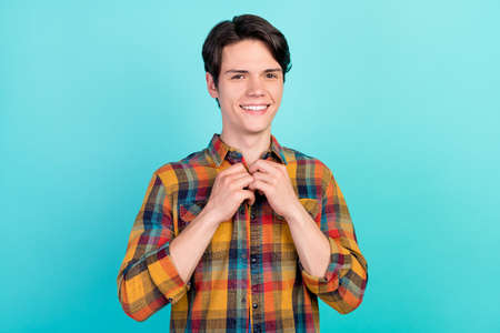 Photo of cheerful confident boyfriend guy fix button collar wear plaid shirt isolated aquamarine color backgroundの写真素材
