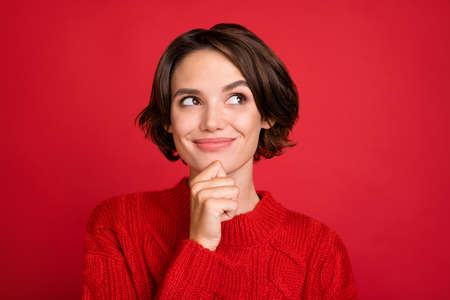 Photo portrait young woman dreamy looking copyspace thoughtful isolated bright red color backgroundの写真素材