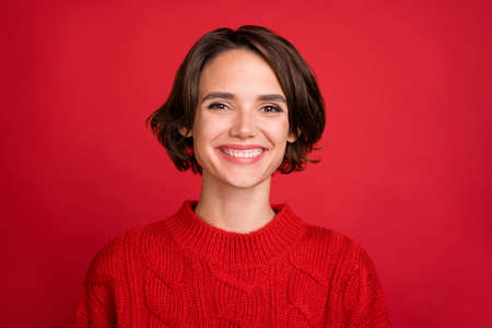 Photo of young cheerful woman happy positive smile spirit atmosphere newyear isolated over red color backgroundの写真素材