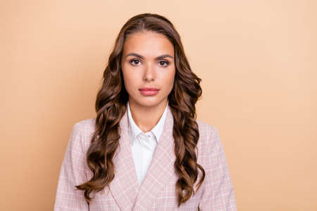 Photo of gorgeous clever young person look camera wear checkered isolated on beige color backgroundの写真素材