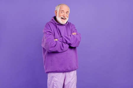 Portrait of attractive funny cheerful man folded arms laughing isolated over bright violet purple color backgroundの写真素材