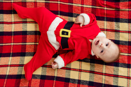 High angle top view photo of young little boy newborn wear christmas costume atmosphere winter holiday indoorsの写真素材