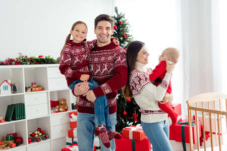 Photo of people mother father sister brother celebrate new year wear sweater in decorated x-mas home indoorsの写真素材