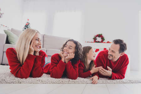 Portrait of beautiful handsome full big family wife husband brother sister lying on carpet spending time at home house indoorsの写真素材
