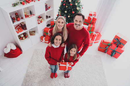 Top above high angle full length body size view of beautiful handsome cheerful family eve congrats spirit at white home house indoorsの写真素材