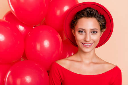 Photo of charming attractive cheerful lady balloons party mood smile enjoy isolated on pastel beige color backgroundの写真素材