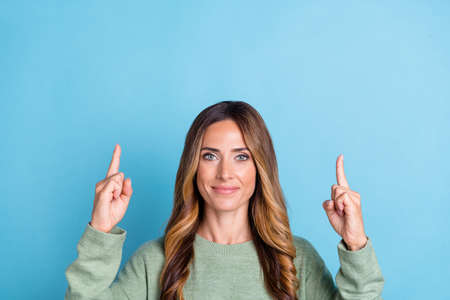 Photo portrait woman smiling showing fingers up copyspace isolated pastel blue color background
