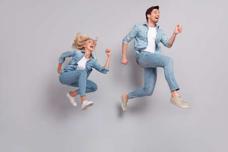 Full length body size view of beautiful handsome friends friendship jumping running isolated over...