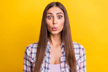 Photo of young attractive woman pouted lips send air kiss lovely isolated over yellow color backgroundの写真素材