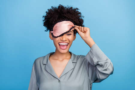 Photo of young excited afro girl have fun awakening eye mask cover eye bedroom isolated over blue...