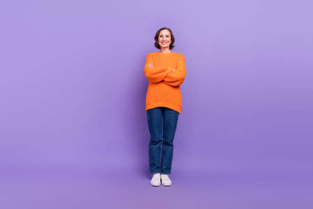 Full body photo of attractive woman confident crossed hands cool isolated over purple color backgroundの写真素材