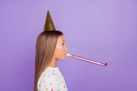 Profile photo of surprised small lady celebrate birthday blow whistle wear dotted pajama isolated purple color backgroundの写真素材