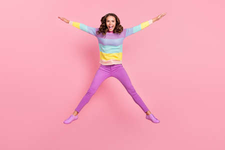 Full size photo of young excited girl have fun jump casual outfit isolated over pastel color...
