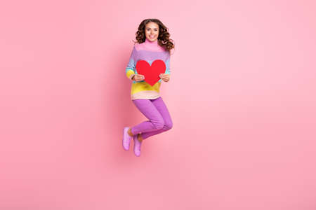 Full size photo of young excited girl jump heart shape valentine day date isolated over pastel color...