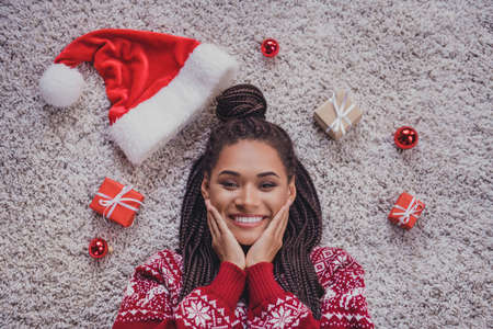 Top above high angle view portrait of attractive delighted cheerful girl lying on cozy soft carpet enjoying giftboxes order at home indoorsの写真素材