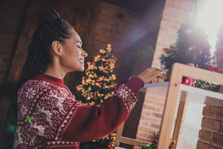 Photo of nice pretty positive lady arrange x-mas decorations prepare present wear pullover in...