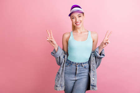 Portrait of attractive cheerful girl showing double v-sign rest free time good mood isolated over...